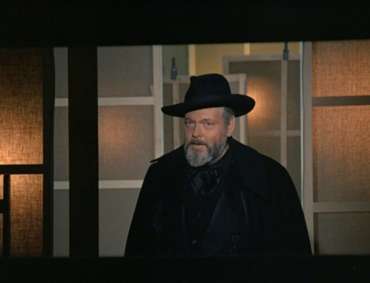 Orson Welles in hat and cape