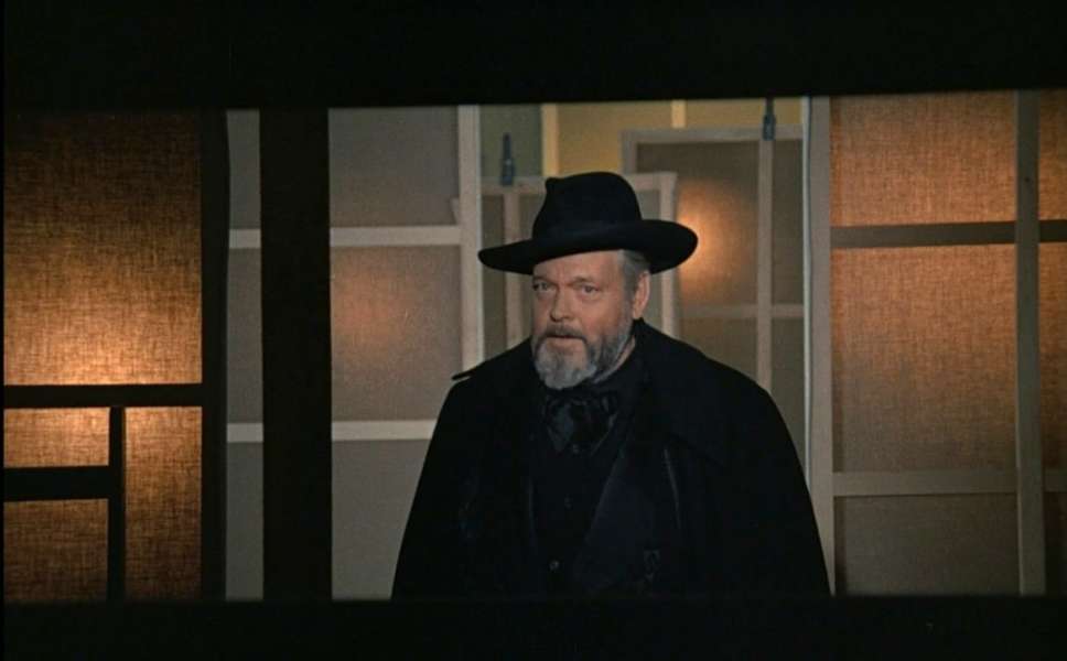 Orson Welles in hat and cape
