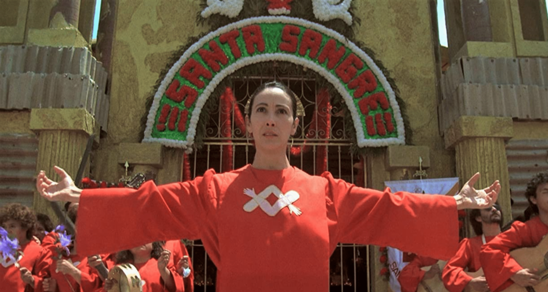 Alejandro Jodorowsky returns to filmmaking after a nearly ten year absence with the surreal horror of 1989's SANTA SANGRE. Filled with wild, controversial imagery, our JodoWOWsky hosts trace its inception, the relationship between Jodorowsky and producer Claudio Argento, the involvement of four of the Jodorowsky children in the production, the taxing filmmaking process, the suggested involvement of Jack Nicholson and Anjelica Huston and SO MUCH MORE. We also discuss the feature length SANTA SANGRE documentary FORGET EVERYTHING YOU HAVE EVER SEEN: THE WORLD OF SANTA SANGRE from 2011, which brings much of the cast and crew together to recount some truly strange stories about the film's inception and legacy. All this and the latest Jodorowsky news, so CHECK IT OUT!